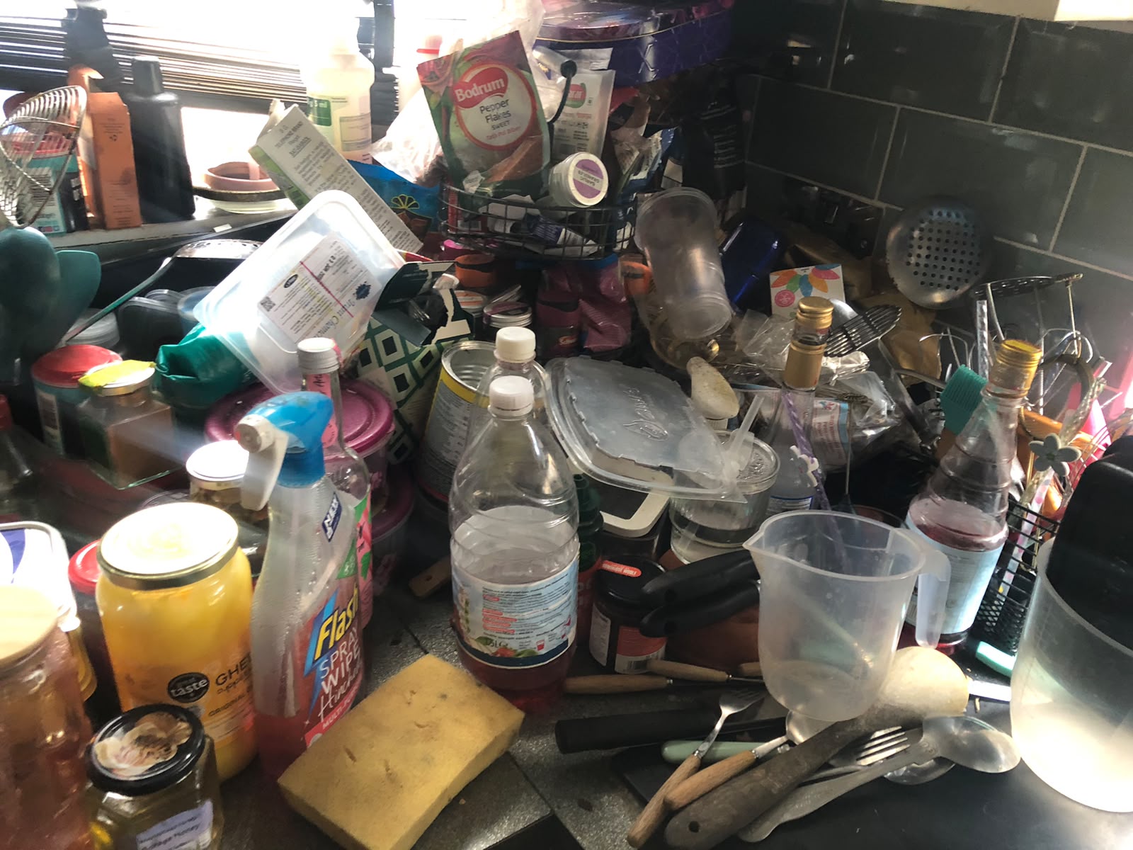 Kitchen worktop declutter — before cleaning
