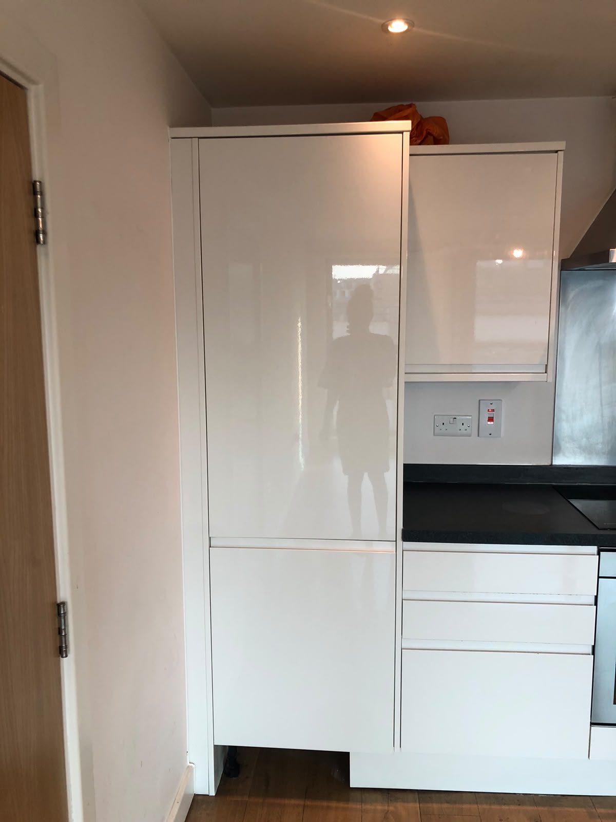 Gleaming white gloss kitchen cabinets